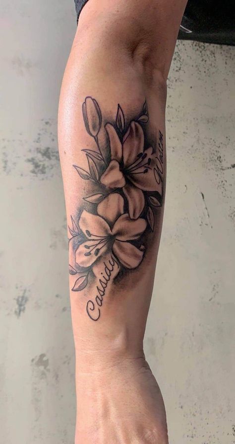 Lily Flower Name Tattoo, Tattoos With Names And Flowers, Flower Tattoo With Names In Petals, Floral Tattoo Design With Name, Flowers Around Name Tattoo, Flamingo Family Tattoo, Front Torso Tattoos For Women, Forearm Tattoo Women Names, Two Name Tattoos