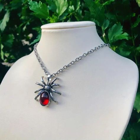 Embrace your inner goth with this stunning handmade silver spider necklace featuring a red teardrop gemstone. #necklaceshop #necklace #gothic #necklaceph #silvernecklace #necklaces #jewelry #jewellery #silverjewelry #silver #jewelryshop #jewelrystore #jewelryoftheday #jewelrylovers #jewelrymaking #halloween #jewelrydesign #jewelrydesigner #jewelrycollection #necklacecollection #necklacelovers #necklaceforsale #necklacemurah #gemstonenecklace #necklaceset #necklacelove #statementnecklace Spider Pendant, Spider Necklace, Witch Jewelry, Goth Jewelry, Crystal Necklace Pendant, Red Crystals, Gothic Jewelry, Crystal Gems, Artistic Jewelry