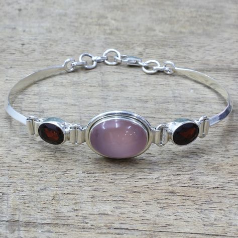 A single, oval-shaped stone of pink chalcedony is flanked by two stones of red garnet that total five carats. Shanker presents a beautiful Indian creation in this bangle bracelet, which is handcrafted from sterling silver by local artisans. Pink Chalcedony, Dope Jewelry, Red Jewelry, Funky Jewelry, Jewelry Inspo, Dream Jewelry, Pendant Bracelet, Red Garnet, Ear Jewelry