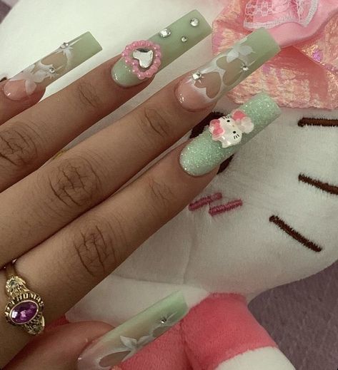 Medium Nails Acrylic Charms, Green Hello Kitty Nails, Y2k Nails Hello Kitty, Long Nails With Charms, Acrylic Nails Hello Kitty, Hello Kitty Nails Long, Sanrio Acrylic Nails, Nail Ideas Y2k Long, Pink Kawaii Nails