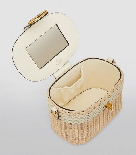 Find VALENTINO Vlogo Signature Vanity Case on Editorialist. This vanity case from Valentino Garavani opens to reveal a mirror and ample space to store your get-ready-to-go essentials. Its straw silhouette gives the impression of a wicker basket, while the detachable shoulder strap allows the accessory to double up as an everyday bag if you're in a rush. Of course, no piece from the brand would be complete without the VLogo hardware, which helps form a clean-cut clasp. Woven Raffia, Vanity Case, Double Up, Wicker Basket, A Mirror, Leather Shops, Everyday Bag, Black Cross Body Bag, Black Mini