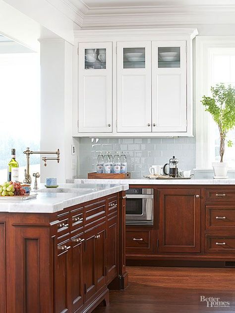 Dark walnut base cabinetry combats marks from heavy use, but upper cabinets with a white-painted finish keep this kitchen light and bright. The custom wood cabinets feature classic paneling and are grounded by stained oak floors. Natural Wood Kitchen Cabinets, Cherry Wood Kitchen Cabinets, Walnut Kitchen Cabinets, White Upper Cabinets, Cherry Wood Kitchens, Clean Kitchen Cabinets, Upper Kitchen Cabinets, Kitchen Luxury, Walnut Kitchen