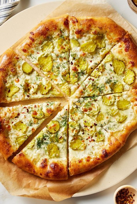 This tasty twist on a classic uses ranch, pickle juice, and dill to make your new favorite pizza. Try our pickle pizza recipe for dinner tonight. Instead of a classic red sauce, this pizza is topped with ranch. It makes a creamy base for tangy dill pickles, mozzarella cheese, and crushed red pepper flakes. #picklepizza #pizzarecipes #homemadepizza #bhg Pickle Pizza Recipe, Pickle Pizza, Pepperoni Recipes, Pizza Cups, Protein Nutrition, Homemade Pizza Dough, Pickle Juice, Pizza Restaurant, How To Make Pizza