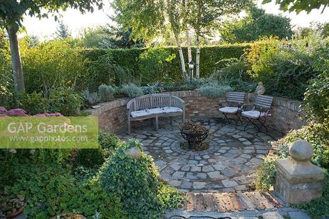 Sunken patio area with seats and border, Garden Hackl, Mistelbach Austria Sunken Seating, Border Garden, Sunken Patio, Circular Patio, Garden Seating Area, Outdoor Seating Area, Sunken Garden, Sloped Garden, Outdoor Gardens Design