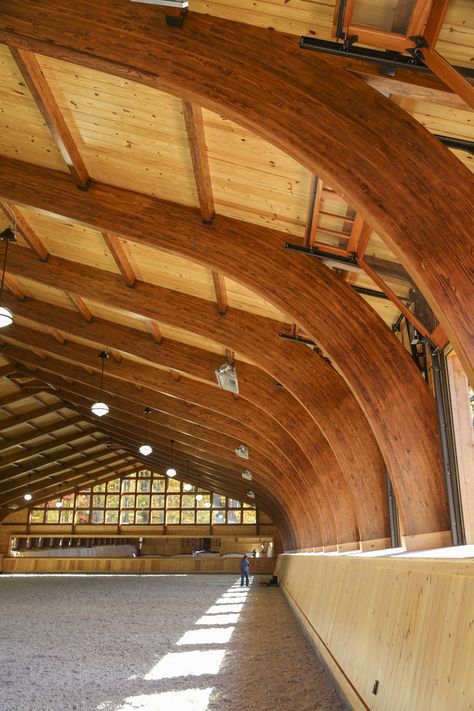 This beautiful 30,000-sq-ft equestrian facility includes an octagonal timber frame barn and an arched riding arena nestled into a hillside. Fine custom details can be found throughout, but the most unique feature may be the arena windows that open fully like garage doors. Equine Facility, Horse Riding Arena, Dream Barn Stables, Equestrian Barns, Riding Arena, Timber Frame Barn, Horse Barn Designs, Dream Horse Barns, Riding Arenas