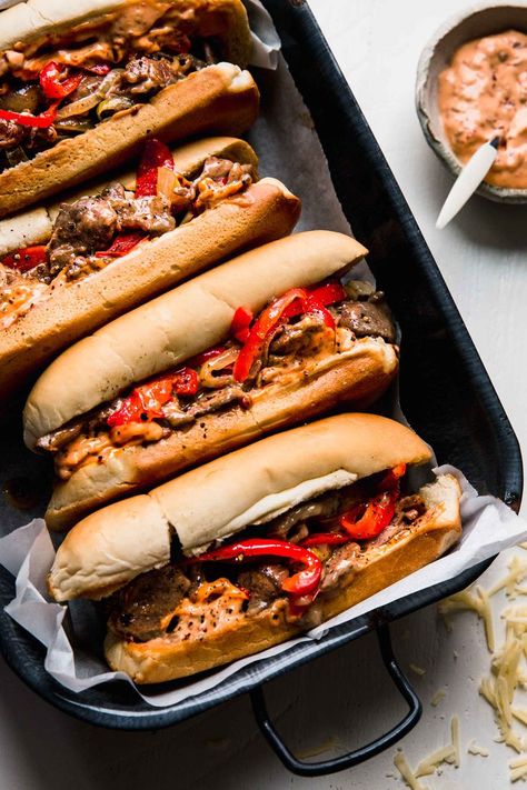 Cheesesteak Sandwiches are the ultimate comfort food. Juicy sliced sirloin, peppers, and onions piled into rolls & smothered with cheese. // recipe // philly Corn Queso Dip, Philly Cheesesteak Sandwiches, Steak Peppers, Cheesesteak Sandwiches, Philly Cheesesteaks, Chipotle Mayo, Cheese Steak Sandwich, Cheese Steak, Sliced Steak