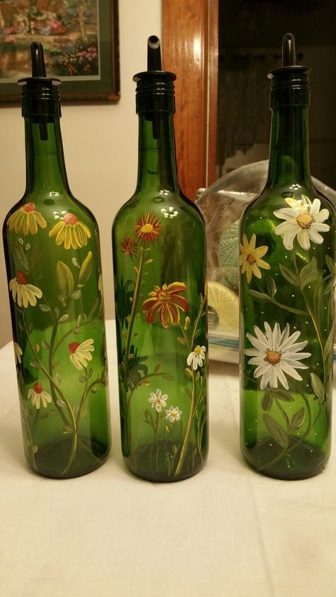 Hand painted wine bottles by Denise Crawford Green Glass Bottles Art, Flower Painted Wine Bottles, Vine Bottle Crafts Diy, Green Bottle Decor, Green Glass Bottles Decor, How To Paint A Wine Bottle, Green Glass Bottle Painting, Green Bottle Painting, Empty Wine Bottle Ideas