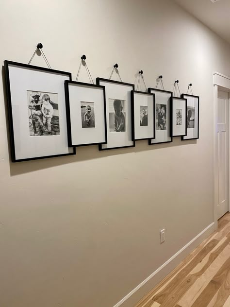 Picture Frames On The Wall Hallway, Picture Frame Layouts On Wall, Dining Picture Wall, Overlapping Picture Frames On Wall, Stacked Photos On Wall, Pictures Entryway, Blank Wall Hallway Ideas, Wall Decor For Pictures, Pictures On Long Wall