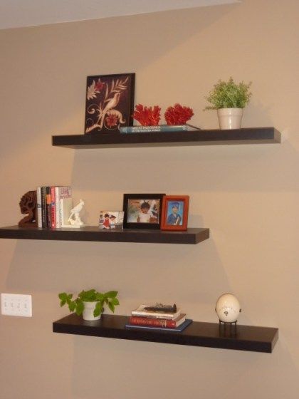 floating shelves, staggered with favorite things Three Floating Shelves, 3 Floating Shelves, How To Decorate Around A Tv, Floating Shelves Entertainment Center, Ikea Floating Shelves, Shelf Arrangement, Long Floating Shelves, Floating Shelves Bedroom, Reclaimed Wood Floating Shelves