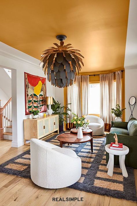 The Best Design Tips for Open Floor Plans, According to the Experts | "Paint is also a great way to help you define space in an open layout," she says. In the Real Simple Home, she did that by painting a vibrant stripe of warm orange paint (Bugle Call by Valspar) along the living room ceiling. Paint a nook or accent wall in a contrasting color to separate areas and visually divide the area. #realsimple #livingroomdecor #livingroomideas #details #homedecorinspo Long Narrow Living Room, Narrow Living Room, Accent Wall Paint, Modern Vintage Decor, Green Sofa, Open Living Room, Living Room Ceiling, Painted Ceiling, Half Bath