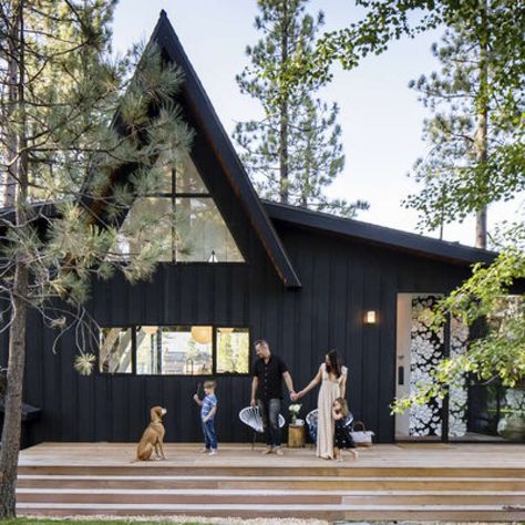 Back in blackExterior paint in Flat Black; dunnedwards.comFrom the moment Jason sketched the A-Frame out on a napkin, the couple knew they wanted it paint the cedar exterior black. “It blends in with the bark on the pine trees that are on the property and keeps the house very hidden from the street,” says Laura. Photo: Thomas J. Story Black Houses, A Frame Cabins, Paint Your House, Cabin Exterior, Sunset Magazine, A Frame Cabin, A Frame House, Black House Exterior, Cabin Style