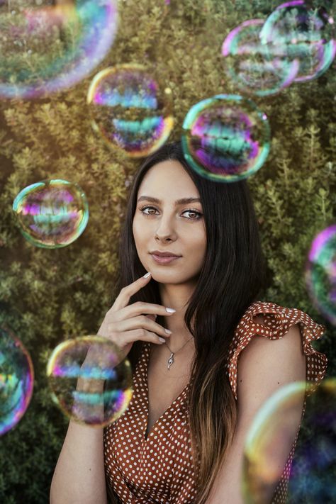 Blowing bubbles in the foreground can make any portrait much more fun and adds some unique depth! Senior Pictures With Bubbles, Blowing Bubbles Photography, Bubble Photoshoot Ideas, Photoshoot Bubbles, Sun Poses, Bubbles Photoshoot, Sophisticated Photoshoot, Bubble Photoshoot, Bubbles Photography