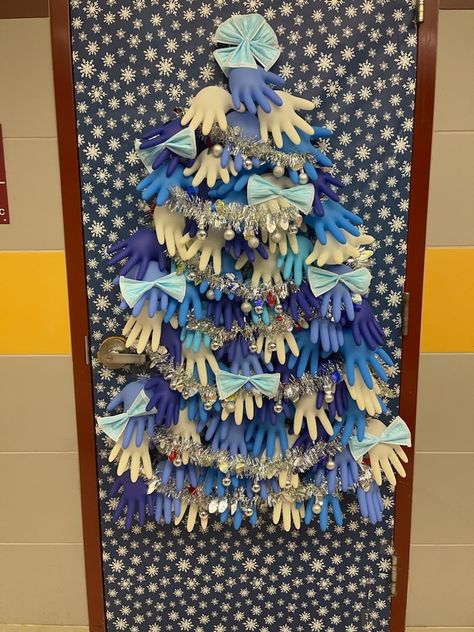 My husband is a school nurse. For his clinic door, he made a tree from surgical gloves and masks and plans to add band-aid boxes for gifts. :) Medical Office Door Decorating Contest, Christmas Medical Office Decorations, Christmas Door Decorations Medical, Nursing Home Door Decorations Christmas, Medical Door Decorating Contest, Christmas Door Decorating Contest Medical Office, School Nurse Door Decoration Christmas, Medical Christmas Door Decorations, Nurse Christmas Door Decorating Contest