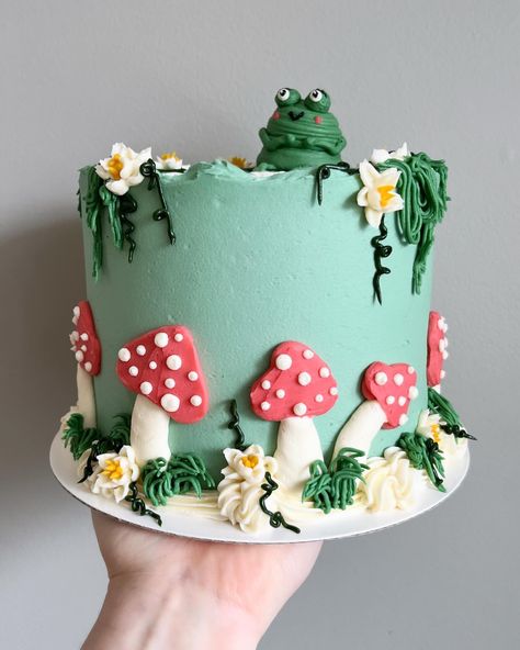 Funky froggy feels 🐸🍄🌿🌼🌾 • • Order sweet swampy cakes on our website 🔗 in bio! • • #frogcake #buttercreamcakes #buttercreamcake #buttercream #buttercreamart #customcake #cakedecorating #cakestagram #cakedesign #instacake #cakeideas #vermontbakery #vermontbaker #homebaker #homebakery #bakergram #vermont #madeinvermont #madeinvt #shelburnevermont #shelburnevt #bluehousebakeshop #cake #baker #pastrychef Buttercream Mushroom Cake, Frog Mushroom Cake, Mushroom Cake Design, Character Cake Ideas, Decorated Cakes Ideas, Mushroom Cake Ideas, Half Moon Cake, Small Cake Designs, Mushroom Birthday Cake