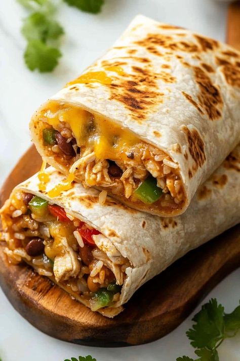 These easy slow cooker chicken burritos make dinner a breeze! With beans, rice, peppers, onions, and salsa, they're guaranteed to satisfy. Crock Pot Burrito Chicken, Healthy Mexican Burritos, What To Do With Burrito Tortillas, Cheesy Chicken And Rice Burritos, Healthy Burritos Recipe, Meals With Salsa Dinners, Bean And Rice Burrito Recipe, Crockpot Chicken For Burritos, Low Sodium Burrito Bowl