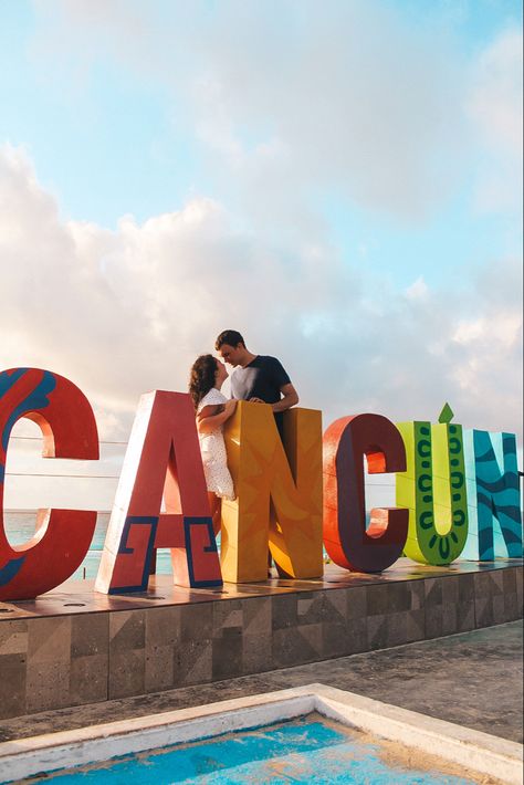 Couple standing in front of colorful Cancun sign in Cancun, Mexico Downtown Cancun, Mexico Bucket List, Ocean Spa, Cancun Photos, Cancun Resort, Cancun Tulum, Explore Mexico, Beach Shoot, Cancun Mexico