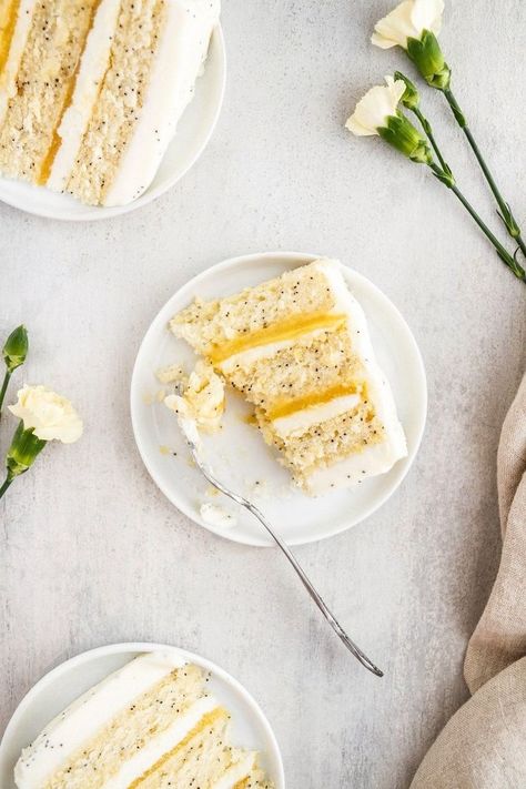 Lemon Poppy Seed Cake -- A delightfully lemony layer cake with lemon curd and a cream cheese buttercream frosting. Cream Cheese Buttercream Frosting, Lemon Poppyseed Cake, Cream Cheese Buttercream, Dessert Cake Recipes, Lemon Poppyseed, Lemon Desserts, Round Cake Pans, Lemon Cake, Lemon Curd