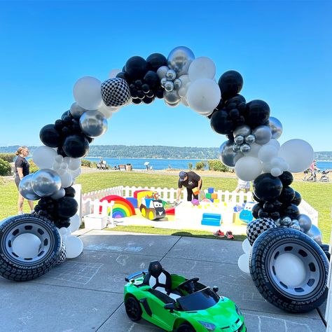 Cars Theme Walkway Arch: Black and White Balloons, Inflatable Tires, and Foil Checkered Accents! 🚗🎈 #CarsTheme #WalkwayArch #InflatableTires #CheckeredBalloons #PartyDecor Walkway Arch, Balloon Entrance, Black And White Balloons, Balloon Business, Balloon Cars, Racing Flag, Balloon Artist, Car Theme, Cars Theme Birthday Party