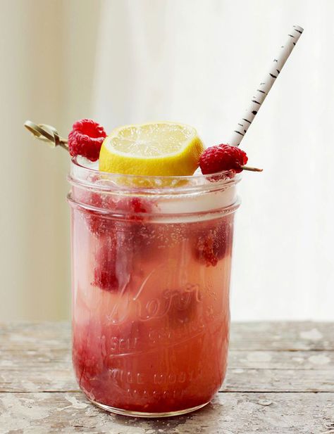 We recommend pouring a whole container—or two, or three—of fresh raspberries into a big batch of this tangy lemonade, perfect for drinking on relaxing, outdoor summer evenings. Get the recipe at A Beautiful Mess.   - CountryLiving.com Raspberry Vodka Drinks, Smirnoff Recipes, Smirnoff Raspberry, Vodka Mojito, Lemonade Sangria, Blue Raspberry Lemonade, Yummy Summer Cocktails, Yummy Summer Drinks, Citrus Vodka