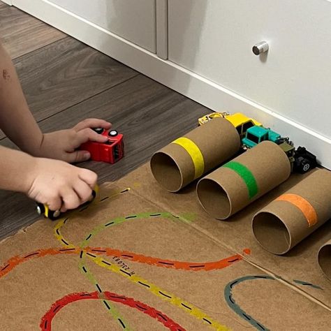 Desiree Blanchard, M.H.K | Baby & Toddler Play on Instagram: "🛑👀STOP THE SCROLL IF YOU LOVE A SIMPLE DIY ACTIVITY! Click the ✨FOLLOW✨ button to continue learning more! To recreate this activity, use TP rolls to make the “garages,” add coloured tape (or marker) on each roll and then tape them flat to a piece of cardboard. We like to use two-way tape for this. Add corresponding “roads” using markers and find small matching coloured cars. That’s it! Have fun! 🫶🏻 ➡️For more, check out my Baby and Toddler Caregiver Play & Milestone guides. It’s loaded with tips, milestones & play ideas! 🔗 in bio • • • #momssupportingmoms #newmomsupport #momoflittles #babysfirstyear #grossmotordevelopment #babydevelopment #babymilestones #mommyandmetime #tummytimefun #newmomsupport #momoflittles #grossmotor Things With Wheels Activities, Car Sensory Activities, Things That Go Activities For Toddlers, Cars Eyfs Activities, Car Toddler Activities, Road Safety Activities For Toddlers, Preschool Wheels Activities, Vehicle Activities For Toddlers, Cars Activities For Toddlers