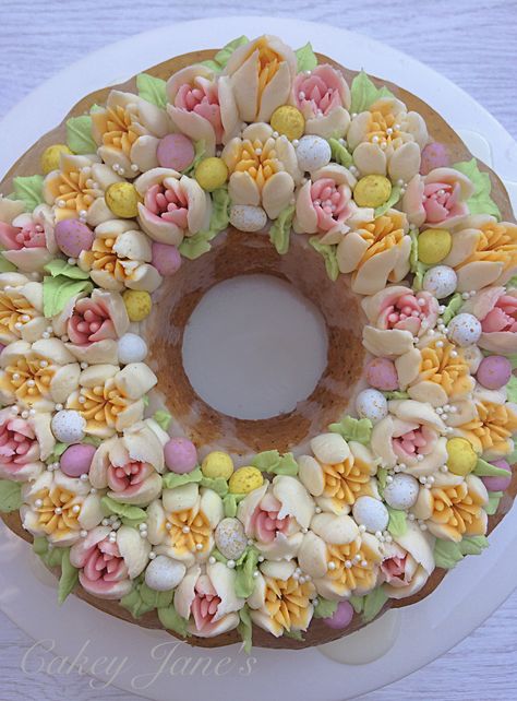 Easter Wreath Bundt Cake: Lemon & Poppy Seed Cake with Lemon & White Rum Drizzle, vanilla buttercream tulips and teeny hidden chocolate eggs Wreath Bundt Cake, Buttercream Tulips, Bundt Cake Lemon, Bundt Cake Decorations, Easter Bundt Cake, Easter Pastries, Lemon Poppy Seed Cake, Bakery Style Cake, Rose Cakes