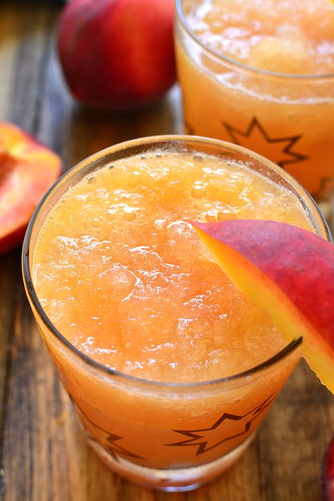 This Frozen Peach Slush is a delicious blend of citrus, peach tea, peach schnapps, and brandy...topped off with your favorite sparkling soda! Perfect for parties, special occasions, or lazy summer days. The perfect drink for summer! Slush Alcohol Drinks, Peach Slush, Peach Schnapps Drinks, Alcoholic Slush, Brandy Slush, Slush Recipes, Peach Drinks, Peach Schnapps, Boozy Drinks