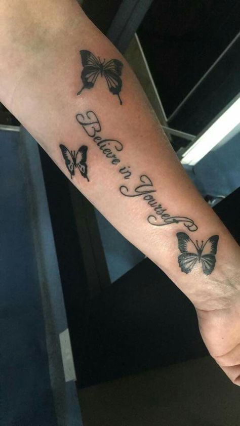 BELIEVE in yourself tattoo with butterflies One Day At A Time Tattoo With Butterfly, Butterfly With Writing Tattoo, Name Tattoos With Butterflies, Butterfly With Words Tattoo, Small Butterfly Tattoo With Quote, Tattoo Quotes With Butterflies, Believe Butterfly Tattoo, Butterfly Tattoo With Words, Butterfly With Script Tattoo