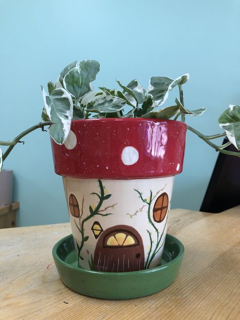 Gnome home style plant pot #potterypainting #ceramcs #paintyourownpottery #flowerpot #paintingideas Cute Clay Pot Painting Ideas, Animal Painted Pots, Fairy House Pottery Painting, Succulent Pot Ideas Paint, Drawing On Pots Ideas, Cottage Core Plant Pots, Mothers Day Plant Pot, Drawing On Plant Pot, Pottery Planter Painting Ideas