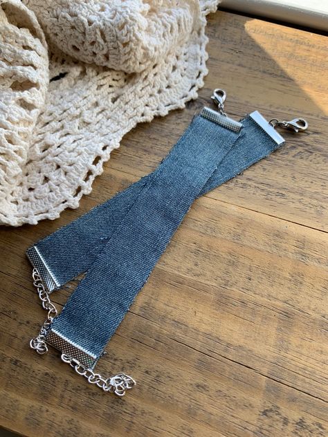 Our original upcycled denim bracelets are made from old blue jeans. Each piece of denim has been used and well-worn. Frayed edges are normal and make your bracelet a unique piece of art. These are ready to be worn, added to your own upcycled arm party, or to be embellished to become your own creation. Length: adjustable, tapes are 6" + 2" chain Width: approximately 1" While you're here, check out our other bracelets and handmade jewelry. And don't forget to sign up for our email list so you'll b Diy Denim Bracelets, Denim Bracelets, Denim Bracelet, Arm Party, Denim Diy, Fabric Cuff, Upcycled Denim, Email List, Unique Pieces