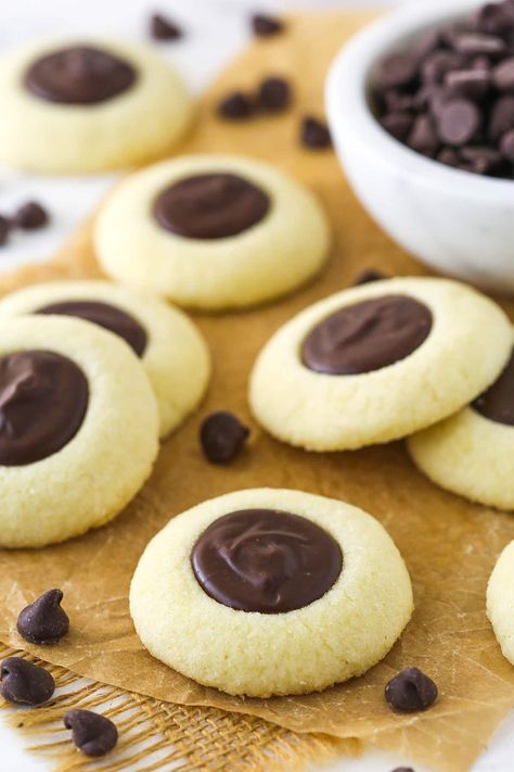 These Chocolate Thumbprint Cookies are a holiday classic! The shortbread-like vanilla cookie base is filled with a silky chocolate ganache for a wonderful cookie you'll come back to each year. Vanilla Shortbread, Chocolate Thumbprint Cookies, Ganache Filling, Chocolate Ganache Filling, Yummy Biscuits, Cookie Base, Ganache Recipe, Holiday Recipes Christmas, Thumbprint Cookies