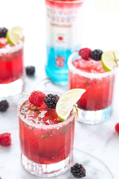 A hybrid between a mojito and a martini, this Triple Berry Mojitini pairs sweet berries with mint, limeade and vodka to bring you this refreshing cocktail! Berry Blast Smirnoff Recipes, Smirnoff Berry Blast Recipes, Smirnoff Red White And Berry Recipes, Smirnoff Cocktails, Smirnoff Red White And Berry, Smirnoff Recipes, Strawberry Blondie, Keto Beverages, Smirnoff Red