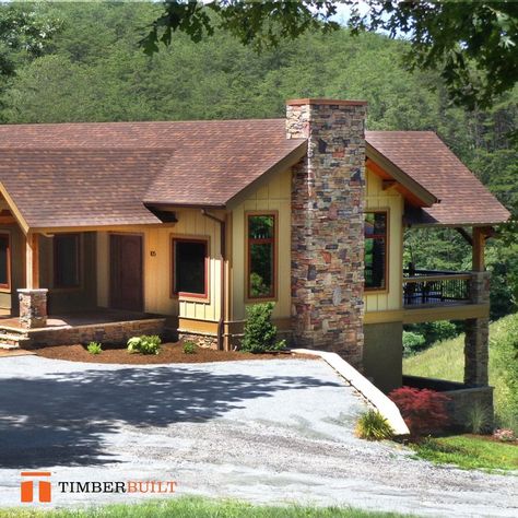 Exterior shot of a medium sized timber frame home finished with a light yellow siding color. The gutters are a bronze color and there is a large stone chimney at one end of the house. This house also has a large covered porch at the front end that's jutting out over a full walkout basement. The roof is covered with brown shingles. Large Covered Porch, Timber Frame Design, Timber Frame House, Timber Frame Home, Stone Chimney, Structural Insulated Panels, Insulated Panels, Design Layouts, Frame House