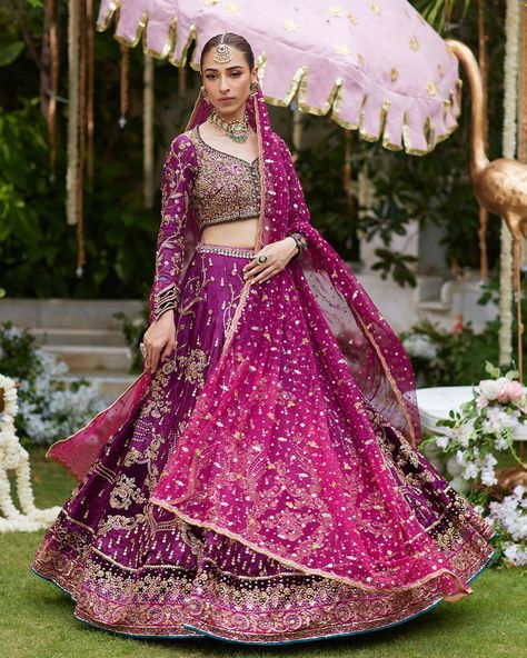 Make a dramatic entrance in the show-stopping plum and magenta two-tone lehenga choli, a masterpiece of contemporary elegance. Heavily embellished with glimmering gold handwork and coordinating silk thread work, this ensemble is a true work of art. The bodice is a marvel of craftsmanship, handcrafted with diamantes that will make you shine like a star amongst the crowd. The lehenga, cut from pure silk jamawar, boasts a stunning ombre effect, with deep plum velvet appliqued on the border of ka... Plum Velvet, Dramatic Entrance, Shine Like A Star, On The Border, Deep Plum, Ombre Effect, Thread Work, Silk Thread, Lehenga Choli