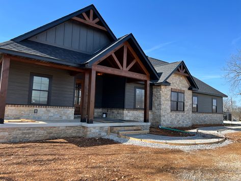 Board And Batten And Rock Exterior, Grey Batten Board Exterior, Dark Gray Siding With Wood Accents, Dark Green House Exterior With Stone, Dark Vinyl Siding House, New Home Outside Design, Black Exterior House With Stone, Light Gray Barndominium Exterior, Hardy Board Siding Farmhouse