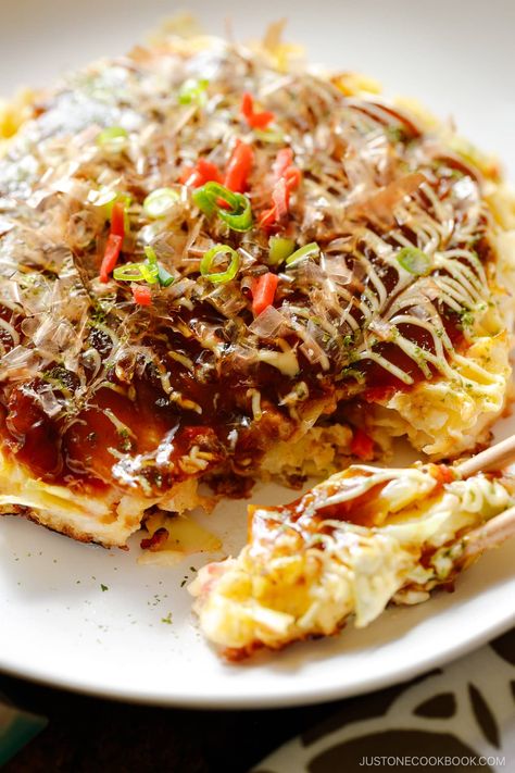 Okonomiyaki is a savory Japanese cabbage pancake “grilled as you like it“ with your choice of protein and tasty condiments and toppings. My recipe for this popular Osaka street food includes the 6 key ingredients that give it a truly authentic taste. Okonomiyaki Recipe, Ginger Pork, Japanese Street Food, Cooking Challenge, Grated Potato, Savory Pancakes, Asian Grocery, Food Challenge, Japanese Cooking