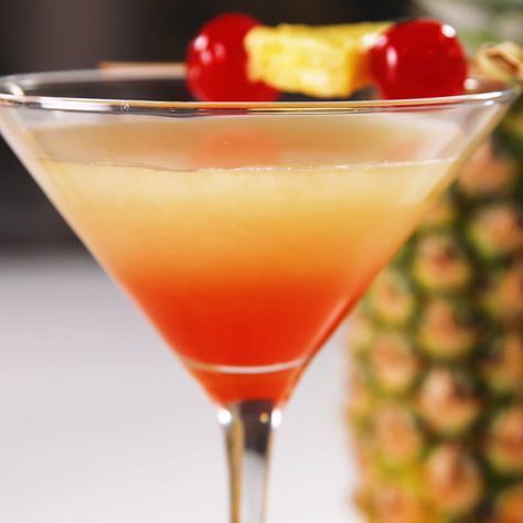 Celebrate summertime with sunset martinis. Not a fan of coconut? Regular rum works just fine! Get the recipe at Delish.com. #easy #recipe #delish #cocktail #alcohol #martini #sunsetmartini #rum #coconut #vodka #pineapple #cocktailrecipes Tropical Martini Recipe, Martinis Recipe, Sunset Martini, Martini Cocktail Recipes, Tonic Cocktails, Cocktails Martini, Martini Recipes Vodka, Vesper Martini, Sunset Cocktail