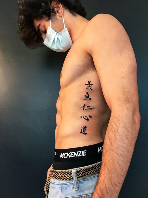 Rib Scar Tattoo, Men Tattoo Ideas Japanese, Japanese Word Tattoo Men, Japanese Symbol Forearm Tattoo, Asian Stomach Tattoos, Japanese Letters Tattoo Men, Japanese Symbol Tattoos Men, Japanese Spine Tattoo For Men, Chest Tattoo Men Ideas Simple