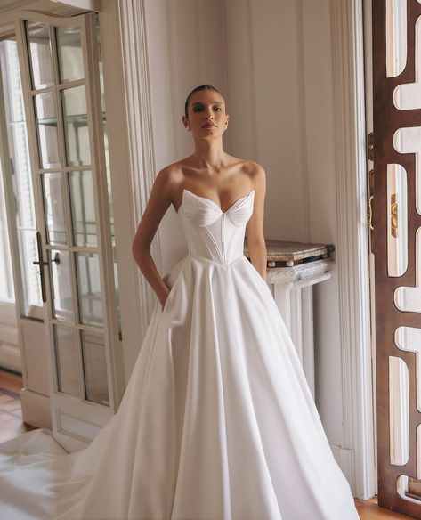 MEET DOVE 🕊 by @wona_concept. A classic aline wedding dress with a stunning basque-waist corset and wing-shaped, pleated cups. This modern beauty also features pockets for functionality and a gorgeous train for added drama. ⁠ ⁠ Price range: $3000 - $4000⁠ ⁠ Available to try on now at our Sydney and Melbourne 2025 @wona_concept Trunk Show where you can preview the entire 'Gemini' collection and receive 10% off your order. Trunk Show ends November 30th. Book now via the link in our bio. ⁠ ⁠ #wo... Sweetheart Corset Wedding Dress, Dove Wedding Dress, Basque Waistline Wedding Dress, Elegant White A-line Corset Dress, Corset Basque Waist Wedding Dress, Cup Wedding Dress, Wedding Dress Basque Waist, Drop Basque Waist Wedding Dress, Wedding Corset Dress With Sweetheart Neckline And Cancan