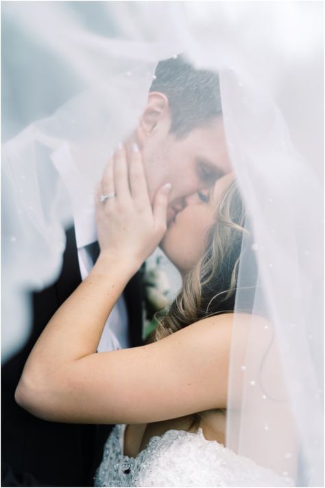 Bride and groom kissing under pearl veil Bride And Groom Kissing Pictures, First Kiss Wedding Pictures Bride Groom, Groom Picking Up Bride Picture, Wedding Kiss Pictures, First Kiss Wedding, Bride And Groom Kissing, Photographer Ideas, Wedding Portrait Poses, Kiss Pictures