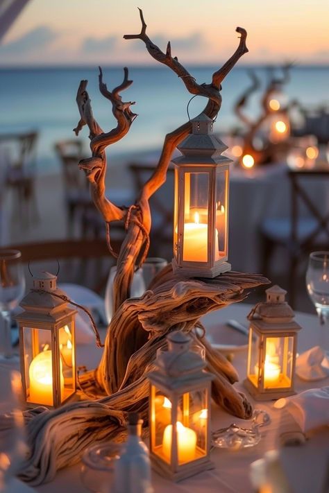 Capture the essence of love with these breathtaking wedding centerpieces. A blend of rustic driftwood and luminous lanterns create an unforgettable seaside ambiance 🌊🕯️. Perfect for brides dreaming of a beach-themed celebration 🏖️✨. #WeddingInspiration #BeachWedding #RomanticDecor #LanternCenterpieces #DriftwoodDecor #WeddingIdeas #Tablescapes #EveningGlow Beach Wedding Lanterns, Driftwood Wedding Centerpieces, Ocean Centerpieces, Seaside Wedding Decor, Driftwood Wedding, Ocean Wedding Theme, Underwater Wedding, Driftwood Centerpiece, Small Beach Weddings