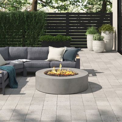 Add just the right amount of warmth to your patio with this fire pit. It has a clean-lined circular silhouette that's made from fiber-reinforced concrete that can withstand the elements out on outdoor space. We love how it has a built-in control panel with an electric ignition and an adjustable flame. This fire pit arrives with lava rocks to help disperse the flame. Plus, it can turn into a coffee table thanks to the included cover. Finish: Flint | Greyleigh™ Conant 12" H x 43" W Concrete Propan Fire Pit Table Ideas, Electric Fire Pit, Outdoor Fire Pit Table, Propane Fire Pit Table, Backyard Fireplace, Concrete Fire Pits, Deck Designs Backyard, Gas Fire Pit Table, Deck Designs