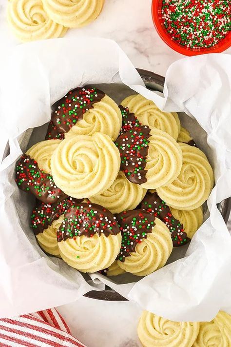 These tender Homemade Butter Cookies are dipped in chocolate and decorated with your favorite sprinkles. They're melt-in-your-mouth delicious and super easy to make! #cookies #buttercookies #cookierecipes #easycookies #holidaycookies #homemadecookies #bestcookies Danish Cookies, Danish Butter Cookies, Chocolate Dipped Cookies, Dipped Cookies, Butter Cookies Recipe, Holiday Cookie Recipes, Chocolate Sprinkles, Homemade Butter, Classic Cookies