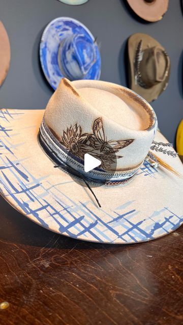 405K views · 16K likes | Alexa Wisnieski on Instagram: "Help me name this one!  *Custom order* . 🦋🌻 Had so much fun working on this custom hat. Incorporating different shades of blue and a very sentimental butterfly. Let’s come up with a name with that in mind!  Drop name suggestions below ⬇️⬇️⬇️ . . #nashville #nasjvilletn #tn #tennessee #art #artist #millinery #milliner #lexlynne #hatmaker #customhat #hatter #creativeprocess #blue #western #westernstyle #weaternfashion #cowboyhat #felthat #paint #countrymusic #newmusic" Diy Burned Felt Hat, Hat Burning Diy, Cowboy Hat Design, Hat Burning, Different Shades Of Blue, Name Suggestions, Head Gear, Instagram Help, Fun At Work