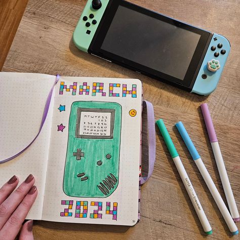 It's officially March! Spring is almost here and PAX East is at the end of the month! My March bullet journal is gaming themed, what's your favorite video game? #videogames #gamer #art #bulletjournal #bujoinspo #bujo #March #hellomarch Gaming Journal, Gamer Art, March Bullet Journal, March Spring, Hello March, Lettering Art, Hand Lettering Art, Game Themes, Bullet Journal Ideas Pages