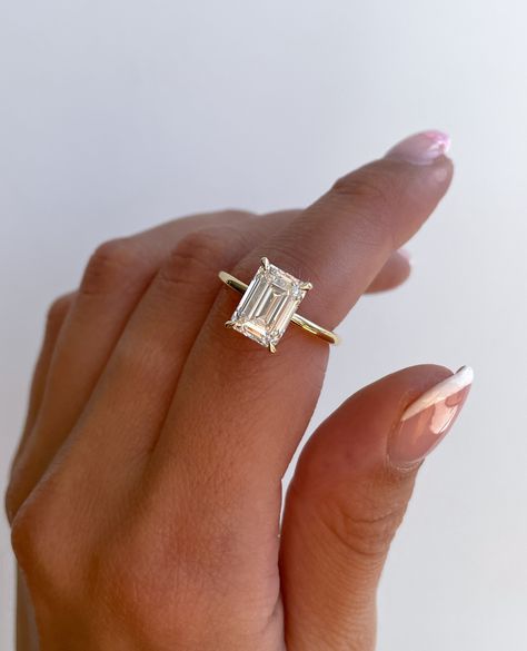 Shopping tip: Prioritise clarity when shopping for an ✨emerald cut✨ stone. ⁠ Due to their step-cut faceting pattern, inclusions can be more visible to the naked eye.⁠ ⁠ We recommend VS1 and above 🤍 ⁠ ⁠ ⁠ Ring Details:⁠ Alice Emerald Solitaire with Hidden Halo⁠ 3.1ct | E | VS1⁠ Emerald Engagement Ring Hidden Halo, Step Cut Engagement Ring, Alexandra Core, Wedding Ring Goals, Gold Emerald Cut Ring, Emerald Shape Engagement Rings, Wedding Ring Emerald Cut, Solitaire With Hidden Halo, Wedding Rings Emerald Cut