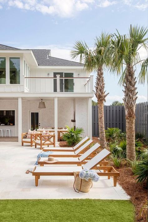 A row of teak pool loungers sit on cream pavers in front of palm trees. Savannah Holly, Slate Pavers, Holly Trees, Pool Loungers, Wooden Pool, White Pergola, Blue Glass Tile, Pool Design Ideas, Pool Pavers