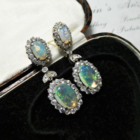 Who else loves an ear dangle?! 😍 A wonderful pair of vintage opal and zircon dangle earrings from the Art Deco era, c1930! Handmade of 9ct rose gold and silver topped, the earrings consists of two oval clusters with precious jelly opal and a halo of natural zircon stones. As the jelly opals have a transparent to translucent body the background can transform the look of them … as we discovered in the imagery! In real life the jelly opals are quite luminous and magical ✨ Victorian Opal Jewelry For Formal Occasions, Opal Drop Earrings With Gemstones, Victorian Oval Opal Jewelry, Luxury Opal Drop Earrings, Silver Opal Dangle Earrings, Jelly Opal, Silver Tops, Jewel Box, Opal Earrings