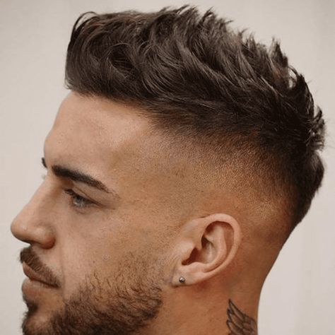 Man with a high fade haircut featuring a spiky top. The hairstyle showcases a clean high fade on the sides and back, contrasting with the voluminous, spiky hair on top. Perfect for a bold and edgy look, this spiky top high fade is ideal for trendy men's hairstyles in 2024. High Fade Haircut Mens, Masculine Haircuts, Fade Haircuts For Men, Trendy Mens Hairstyles, Short Fade Haircut, High Fade Haircut, High Skin Fade, Spiky Hair, Fade Haircuts