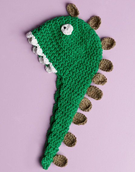 Gelato Dinosaur Baby Beanie Free Crochet Pattern. Materials Needed: • ‘Moda Vera’ Gelato 2 x 50g ball Main Colour (M) green, 1 x 50g ball 1st Contrast (C1) taupe, 1 x 50g ball 2nd Contrast (C2) white • Small amount of black yarn for eyes • 1 x 4.50mm crochet hook or size needed for correct tension. • A stitch marker • Scissors, yarn needle, tape measure Free Pattern More Patterns Like This! Dinosaur Hat Pattern, Free Dinosaur Crochet Pattern, Dinosaur Hats, Crochet Dinosaur Hat, Crochet Hooded Scarf Pattern, Moogly Crochet, Beanie Free Crochet Pattern, Dinosaur Crochet Pattern, Modern Haken