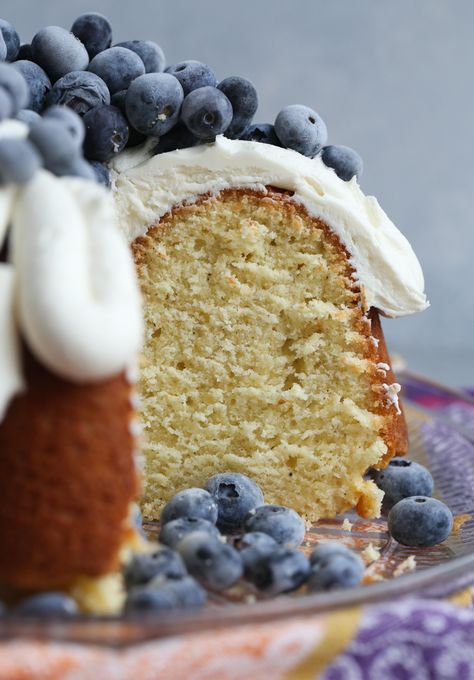 Million Dollar Pound Cake is straight out of my Grandma's recipe box. IT's buttery, dense, soft and moist. I topped mine with honey buttercream and fresh blueberries. It's the PERFECT pound cake! #recipe #bundtcake #cake #baking #cookiesandcups Sweet Munchies, Million Dollar Pound Cake, Honey Buttercream, Pound Cake Glaze, Cake Recipe From Scratch, Glaze For Cake, Pound Cake Recipe, Cake Recipes From Scratch, Pound Cakes